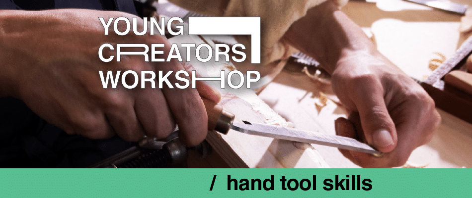 Hands carving wood at the young creators workshop, highlighting hand tool skills.