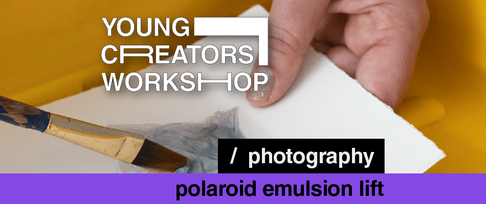 Hands brushing paint on a white card for a young creators workshop on photography and polaroid emulsion lift.