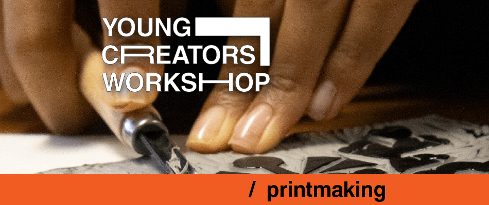 Close-up of hands carving a linocut for printmaking at a young creators workshop.