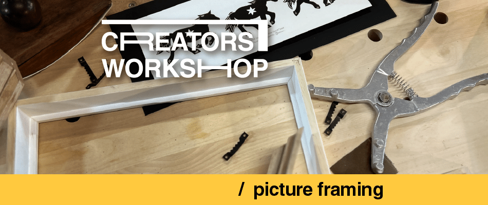 Framing workshop scene with a wooden workbench, a white frame, and pliers; overlay text reads 'creators workshop' and '/ picture framing'.